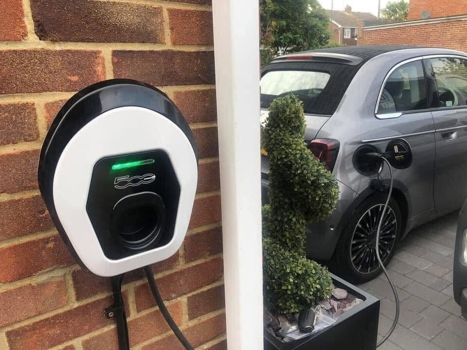 Fiat 500 EV charger installed on brick wall
