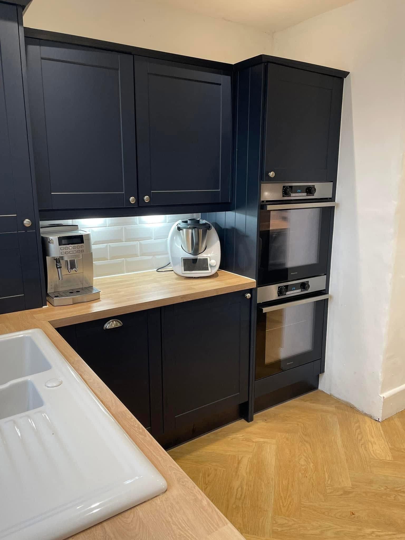 Navy blue fitted kitchen with double ovens